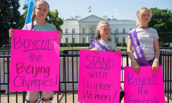 ホワイトハウス前で、人権問題を理由に北京冬季五輪のボイコットを主張するメッセージボードを掲げる小さな抗議者たち（Saul Loeb/AFP via Getty Images）