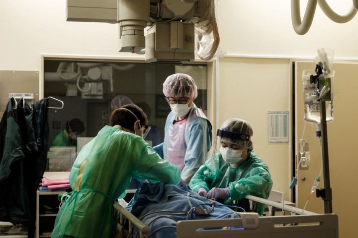 2021年8月8日、横浜市の聖マリアンナ医科大学病院で、コロナ感染が疑われる患者に防護具（PPE）を着用した医療従事者が対処している（Photo by YASUYOSHI CHIBA/AFP via Getty Images）