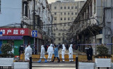 2022年1月21日、上海市黄浦区昭通路の住宅地で市防疫職員が周辺を封鎖している（STF/AFP via Getty Images）